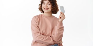 Happy woman with Marriott Bonvoy Business American Express credit card.