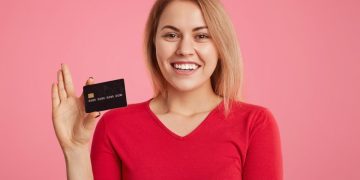 A happy woman with the Scotiabank American Express card.