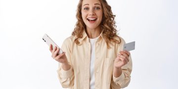 Woman using a a Tangerine World mastercard credit card.