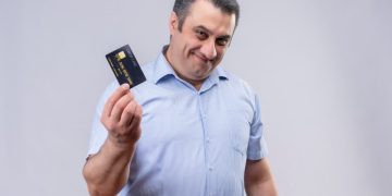 A man holding his Aeroplan Credit Card.