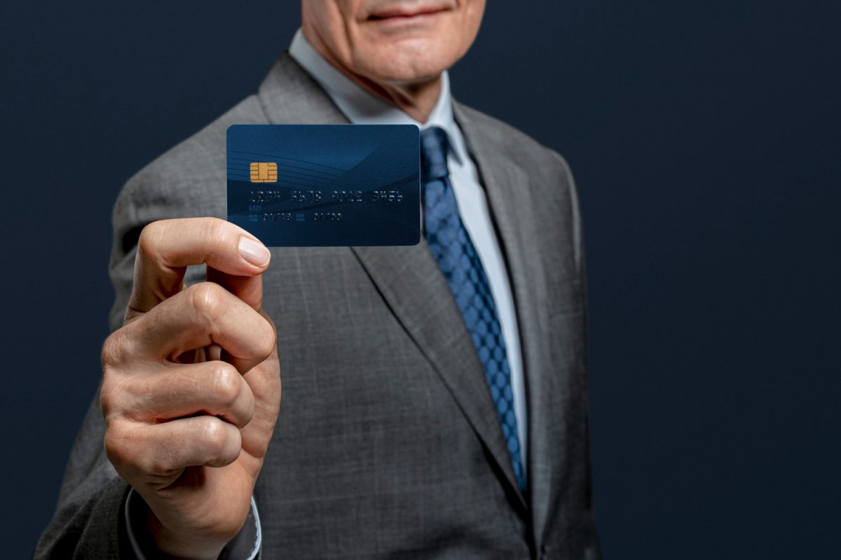 A man holding his Bank of America Travel Rewards.