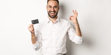 A man holding his Bilt Mastercard credit card.