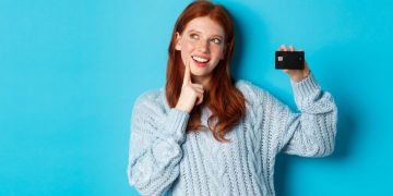 Woman holding her Discover it Balance Transfer Credit Card.