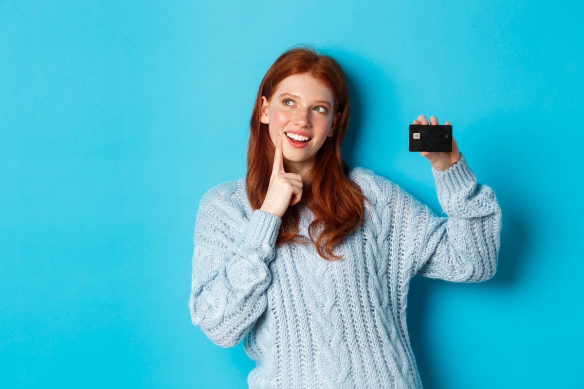 Woman holding her Discover it Balance Transfer Credit Card.