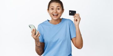 Happy woman with her Discover it Balance Transfer Credit Card.