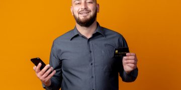 A man holding his GM Business Card.