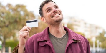 A man being happy about the Rewards Credit Card.