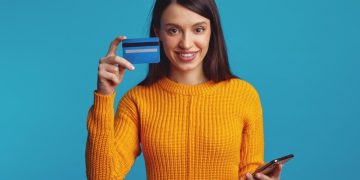 Happy woman using her Self Visa Secured Credit Card.