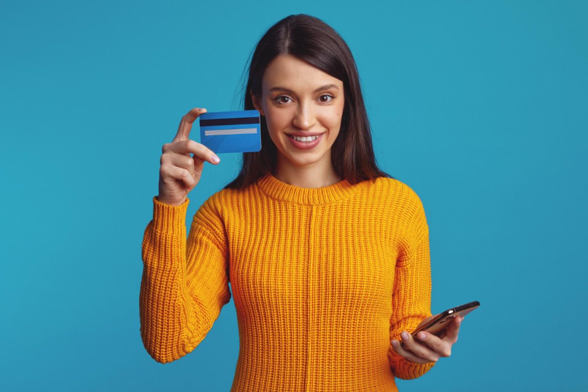 Happy woman using her Self Visa Secured Credit Card.