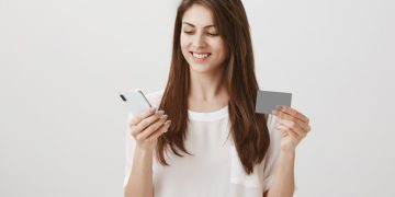 Woman holding her Simmons Visa Credit Card.