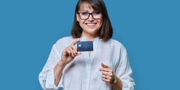 Woman holding her United Explorer Card.