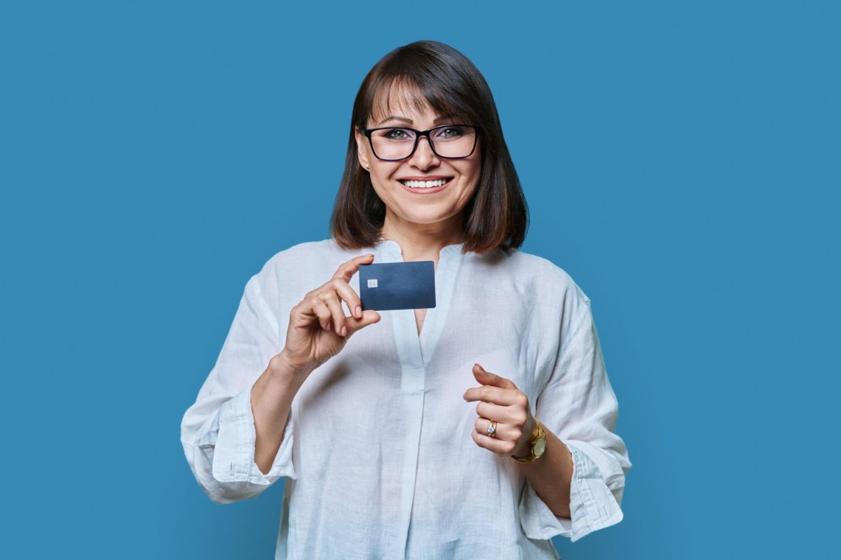 Woman holding her United Explorer Card.