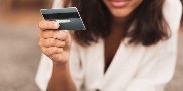 Woman holding her Wells Fargo Active Cash.