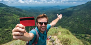 A man using his travel credit cards on a trip.