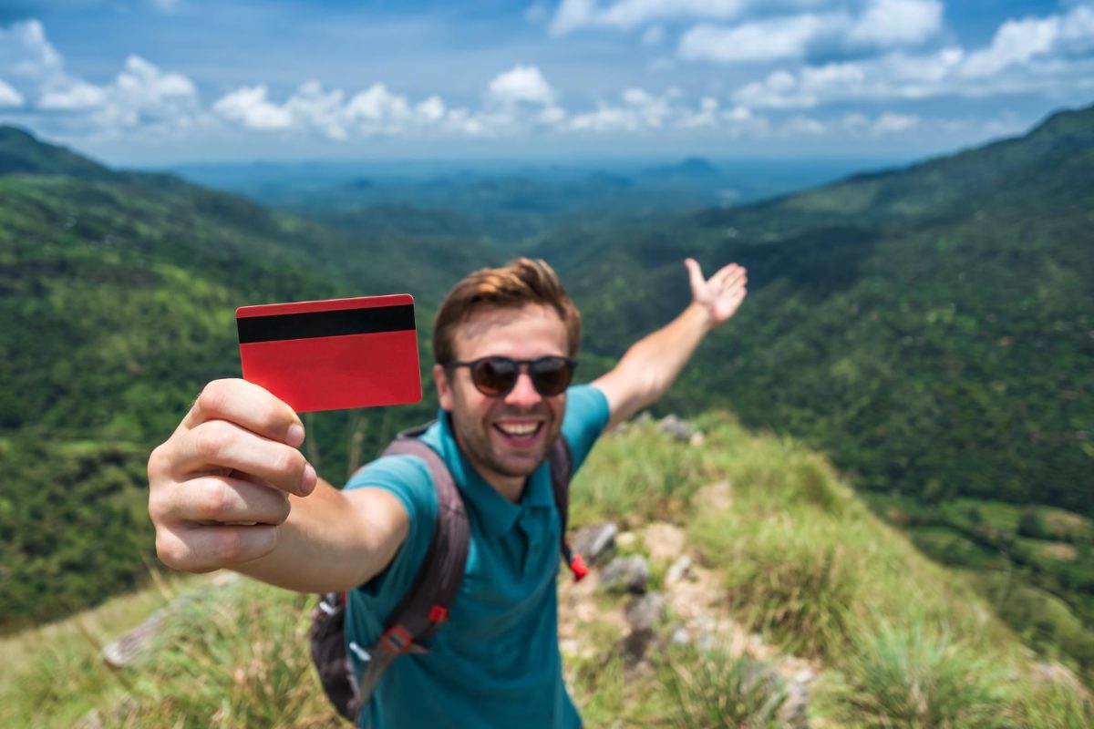 A man using his travel credit cards on a trip.