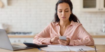 Woman checking Non-Sufficient Funds Fees oh her account.