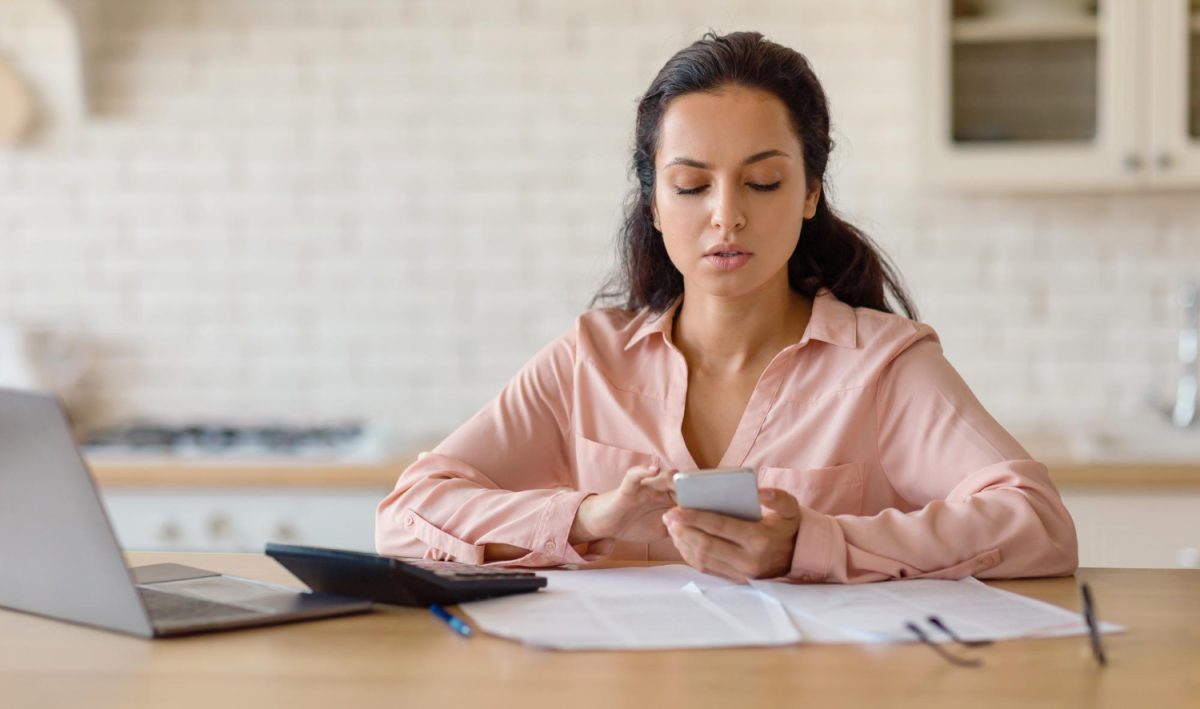 Woman checking Non-Sufficient Funds Fees oh her account.