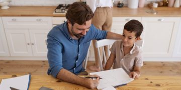 Dad using Savings account for kids with his son.